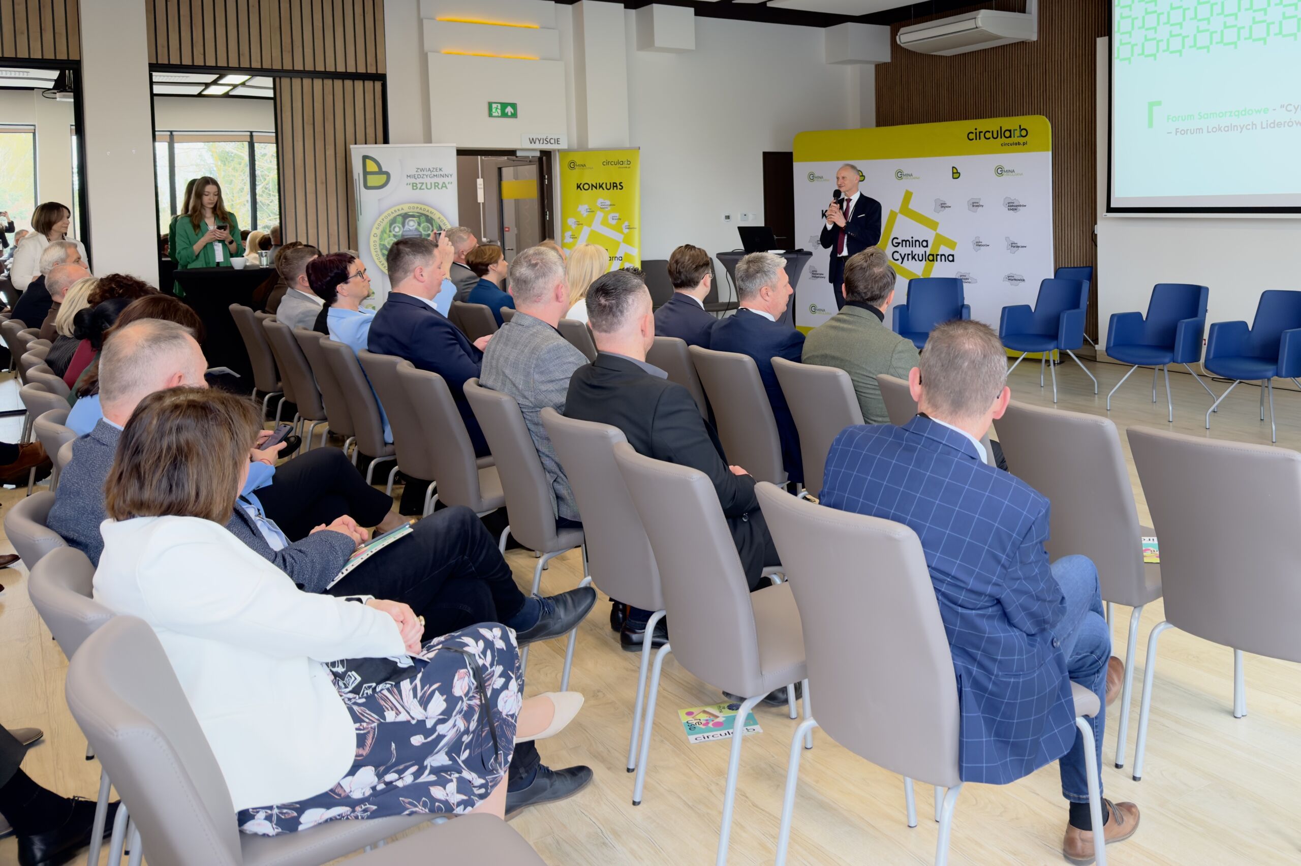 Uczestnicy festiwalu cyrkularności siedzą na sali konferencyjnej